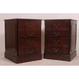 A pair of antique style mahogany and leather pedestal filing cabinets.