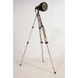 A vintage 20th century theatre / cinema external spot lamp raised on a painted shabby chic wooden