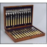 An Edwardian oak cased 12 piece fish cutlery canteen marked for JD&S ( James Dixon & Sons,