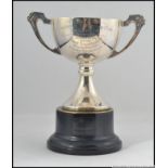 A silver hallmarked trophy on ebonised plinth.