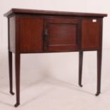An Edwardian mahogany washstand cabinet raised on squared legs with single cupboard door.