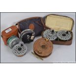 A collection of vin tage fishing reels six in total, to include wooden and alloy,