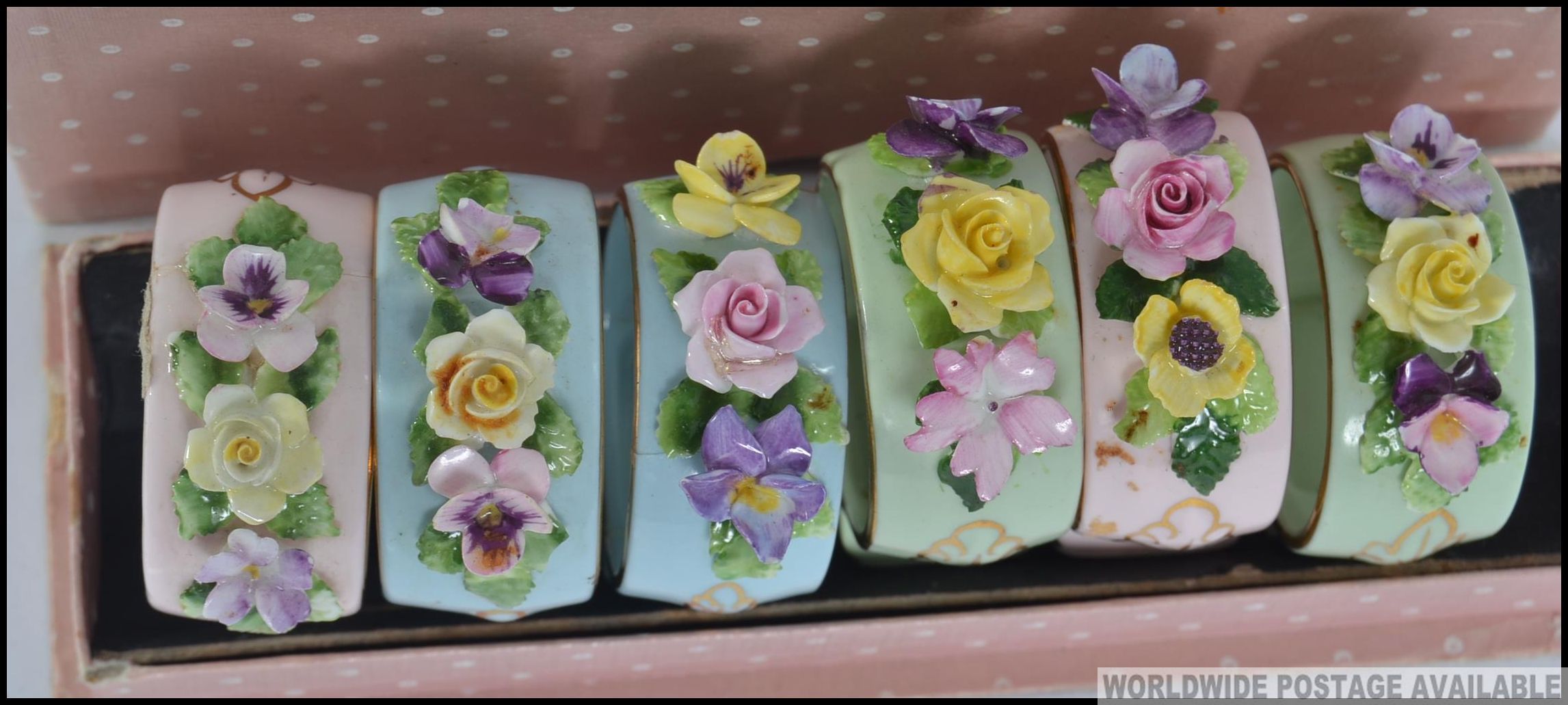 A cased set of mid century ceramic napkin rings embellished with floral sprays complete in the - Image 2 of 3