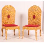 A pair of unusual gilt metal Indian wedding throne chairs having gilded metal overlays to the back