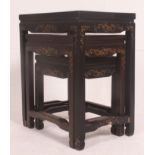 A Chinese black laquered soapstone inlaid nest of tables.