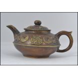 A good Chinese brass yi-xing teapot complete with the lid having embellished coin and character