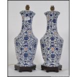 A pair of 20th century Japanese blue and white vases having a rich blue background with a foliate