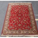 A large French Persian rug having red ground with geometric borders having label to verso for