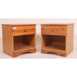 A pair of 20th century antique style pine bedside cabinet tables being raised on bun feet with