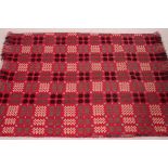 A stunning 20th century Welsh blanket in red with white, grey and black medallion design.