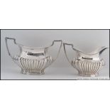 A late Victorian silver hallmarked sugar bowl and creamer by Cooper Brothers & Sons, Sheffield 1900.