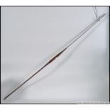 A 20th century African spear, the front end has a blade formed on a metal shaft,