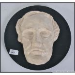 A 20th century study plastercast Death Mask of an elderly gent mounted on to board.