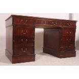 An antique style mahogany and leather twin pedestal writing desk.