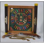 A framed and glazed hanging collection of shotgun cartridges being baize lined within together with