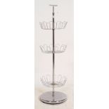 A retro 1970's chrome shop display stand having 3 basket graduating tiers with carry handle atop.