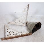 2 Victorian painted cast iron architectural wall brackets together with a salvaged rain hopper.