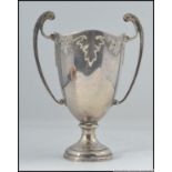 An Edwardian silver hallmarked Art Nouveau trophy being twin handled with acanthus leaf design.