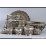 A collection of Indian white metal items to include lidded pots,