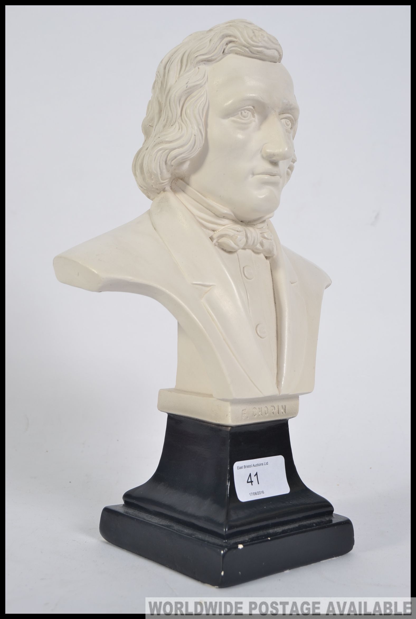 A 20th century plaster bust of Chopin being raised on a socle plinth base with notation.