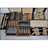 A collection of assorted flatwares to include boxed butter knives,
