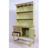 A vintage 1930's painted oak shabby chic welsh dresser raised on turned supports with cupboards and