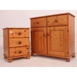 A 20th century antique style pine sideboard cabinet with cupboards and drawers together with a