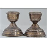 A pair of silver hallmarked stub candlesticks. Hallmarks for Broadway and Co, Birmingham 1971.