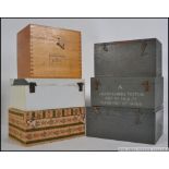 A collection of vintage wooden boxes, mainly of military origin ,