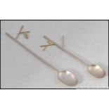 A pair of Scottish contemporary silver hallmarked teaspoons having twig and leaf design.