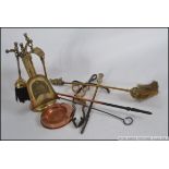 A mixed collection of copper and brassware from the mid century mostly consisting or hearth items -