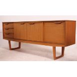 A retro 1970's teak wood Danish inspired sideboard having a straight three drawers flanked by a