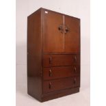 A 1930's oak Art Deco tallboy having drawers under linen cupboard above.