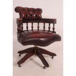 An antique style mahogany and leather captains swivel desk office chair.