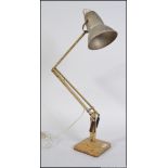 An early 20th century Herbert Terry scrumble finish anglepoise desk lamp raised on twin step base