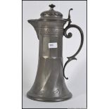 A large 20th century pewter tankard jug with lid having scrolled handle.