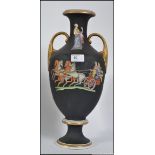 A Victorian terracotta twin handled amphora vase having black ground and transfer printed with