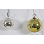 2 vintage 20th century coloured glass witch balls to include a large gold example and a smaller