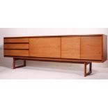 A good retro 1970's long Danish revival teak sideboard raised on shaped supports,