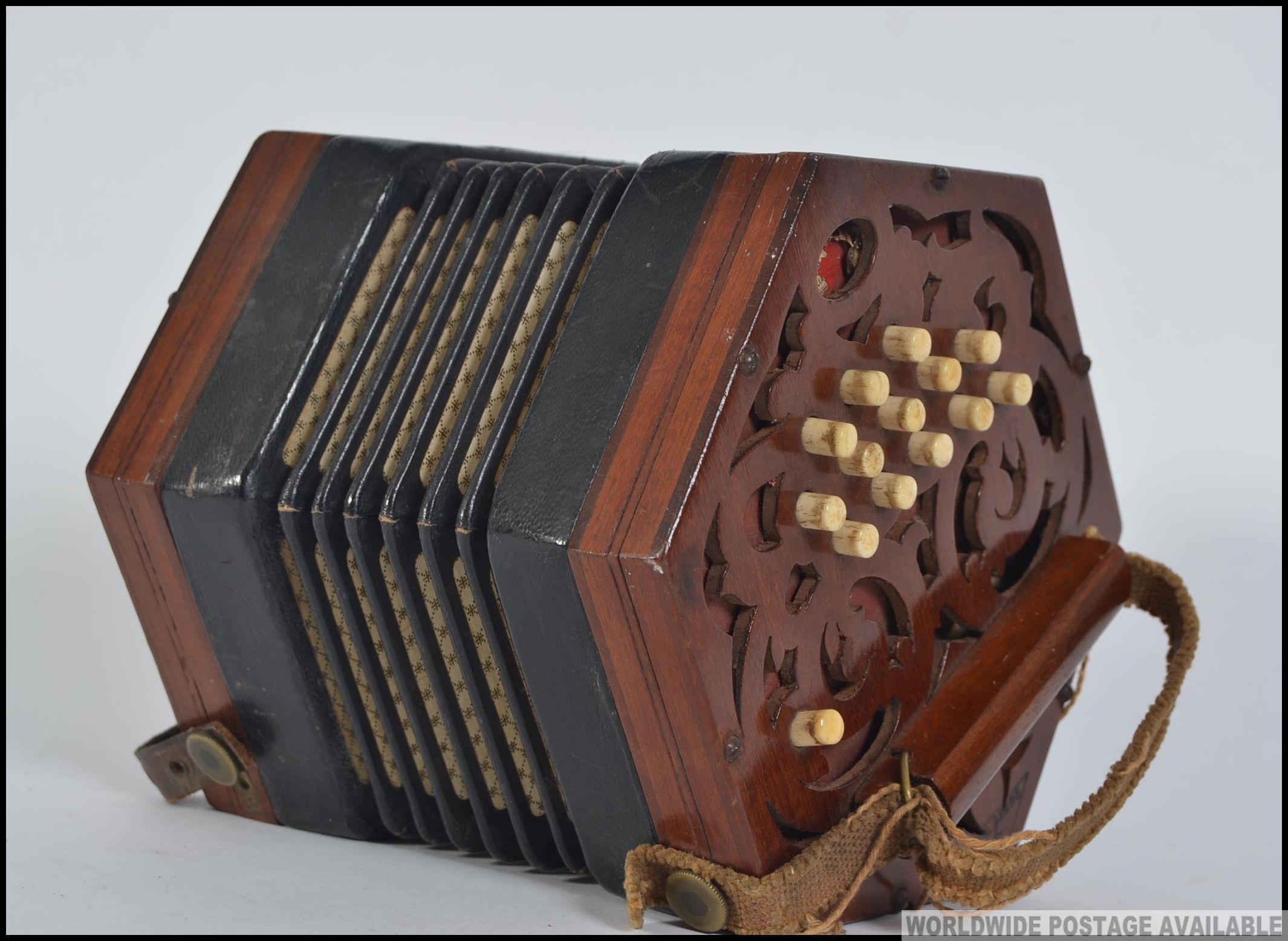 A Victorian mahogany squeeze box musical instrument.