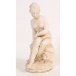 A 20th century reconstituted stone figure of a semi clad maiden / lady in a classical pose,