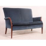 A retro Parker Knoll teak show wood framed sofa of smaller proportions,
