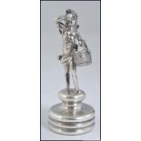 A 19th century.silver hallmarked bottle cork top with winged cherub and basket adornment.