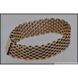 A 9ct gold mesh link bracelet with clip clasp and safety chain. Maker C & F.