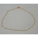 A 9ct gold flat link Figaro chain anklet with spring hoop clasp. Marked 375.