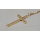 A hallmarked 9 ct gold crucifix cross pendant necklace with a foliate chase decorated crucifix