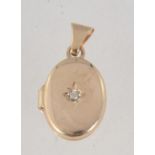 A 9ct gold and diamond locket pendant set with single diamond in a star setting approx 2pts.