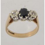A hallmarked 9ct gold sapphire and diamond trilogy ring with a large prong set oval cut sapphire