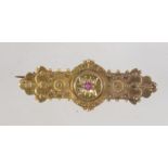 A Victorian 15ct gold ruby and diamond brooch pin with granulated and filigree decoration set with