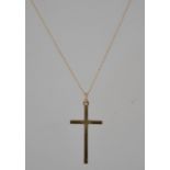 A hallmarked 14ct gold pendant necklace strung with a 9ct diamond cut decorated crucifix on gold